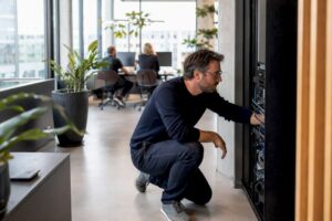 Un chef d’entreprise de PME en train de régler le matériel numérique dans son atelier